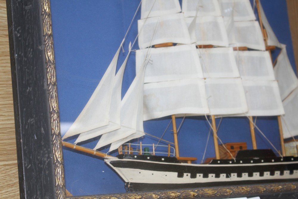 A painted wood ship model, in display frame, overall 42 x 52cm